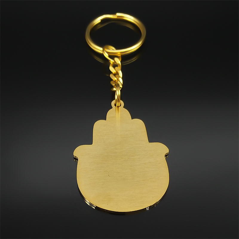 Porte-clés doré en acier inoxydable, forme Hamsa avec décor de Jérusalem gravé.
